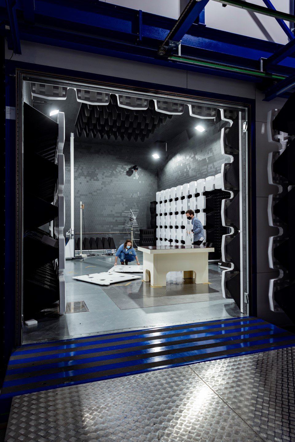 Two Kiwa employees building a test setup within the Radio & wireless testing facility