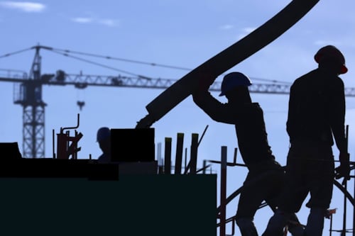 construction workers building a facility with cement-related materials