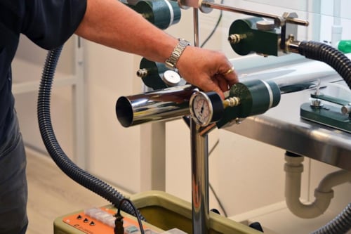 middle-aged gentleman calibrating a measuring device for accurate readings, during an inspection