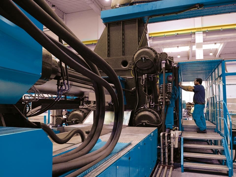 kiwa employee conducting an inspection of machinery safety in a factory